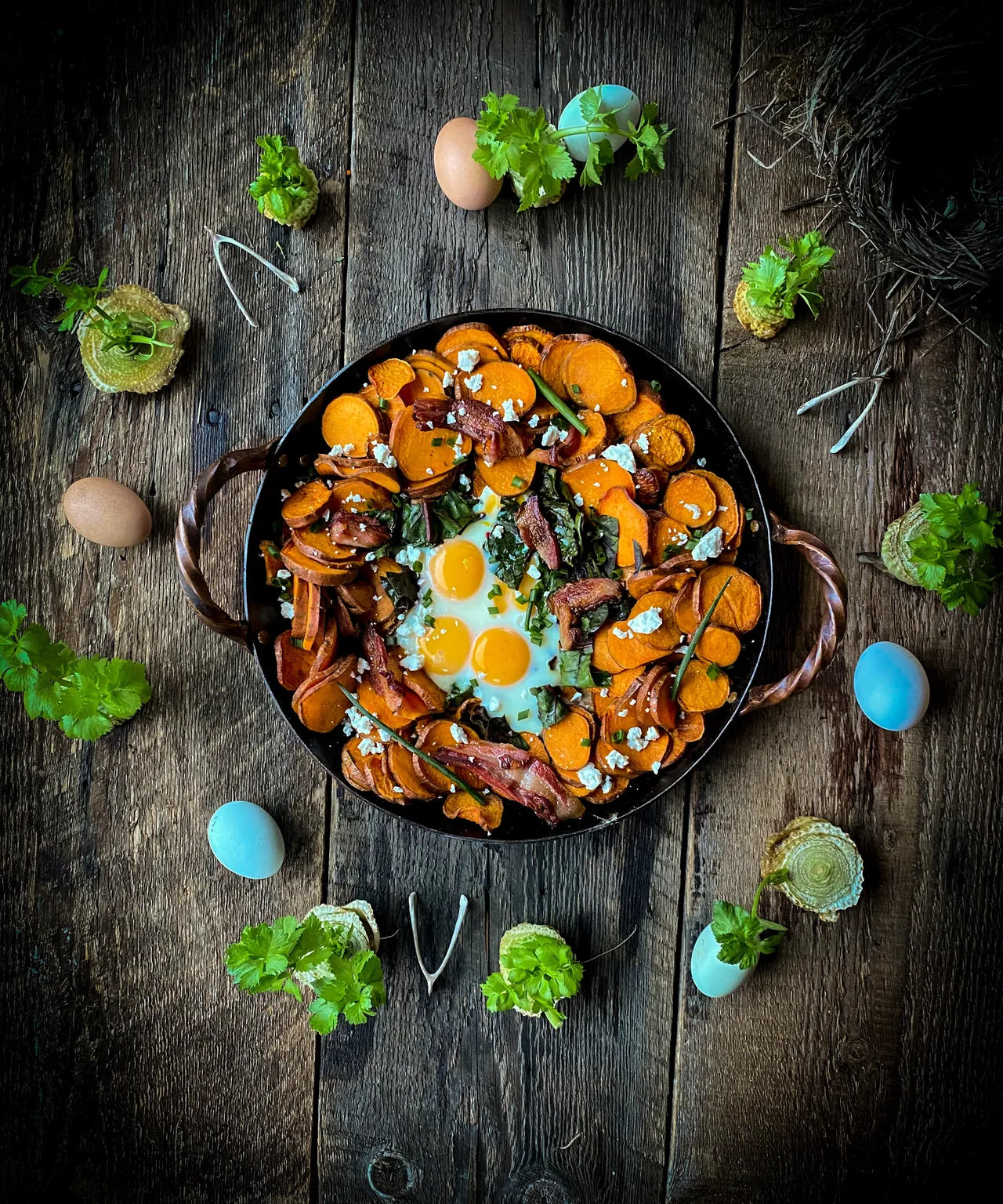Skillet of eggs and sweet potato home fries with bacon