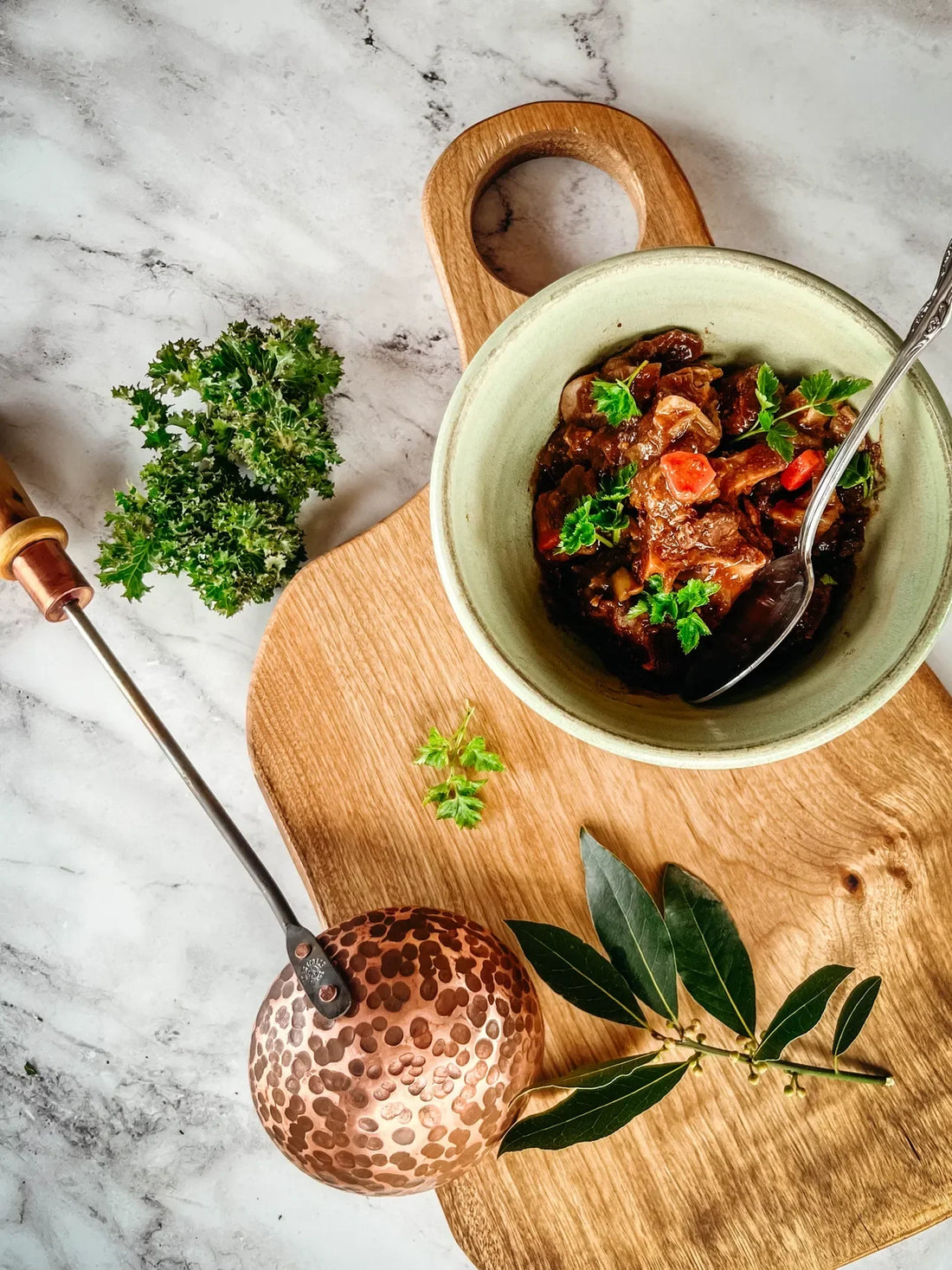 Bowl of meatball soup with herbs